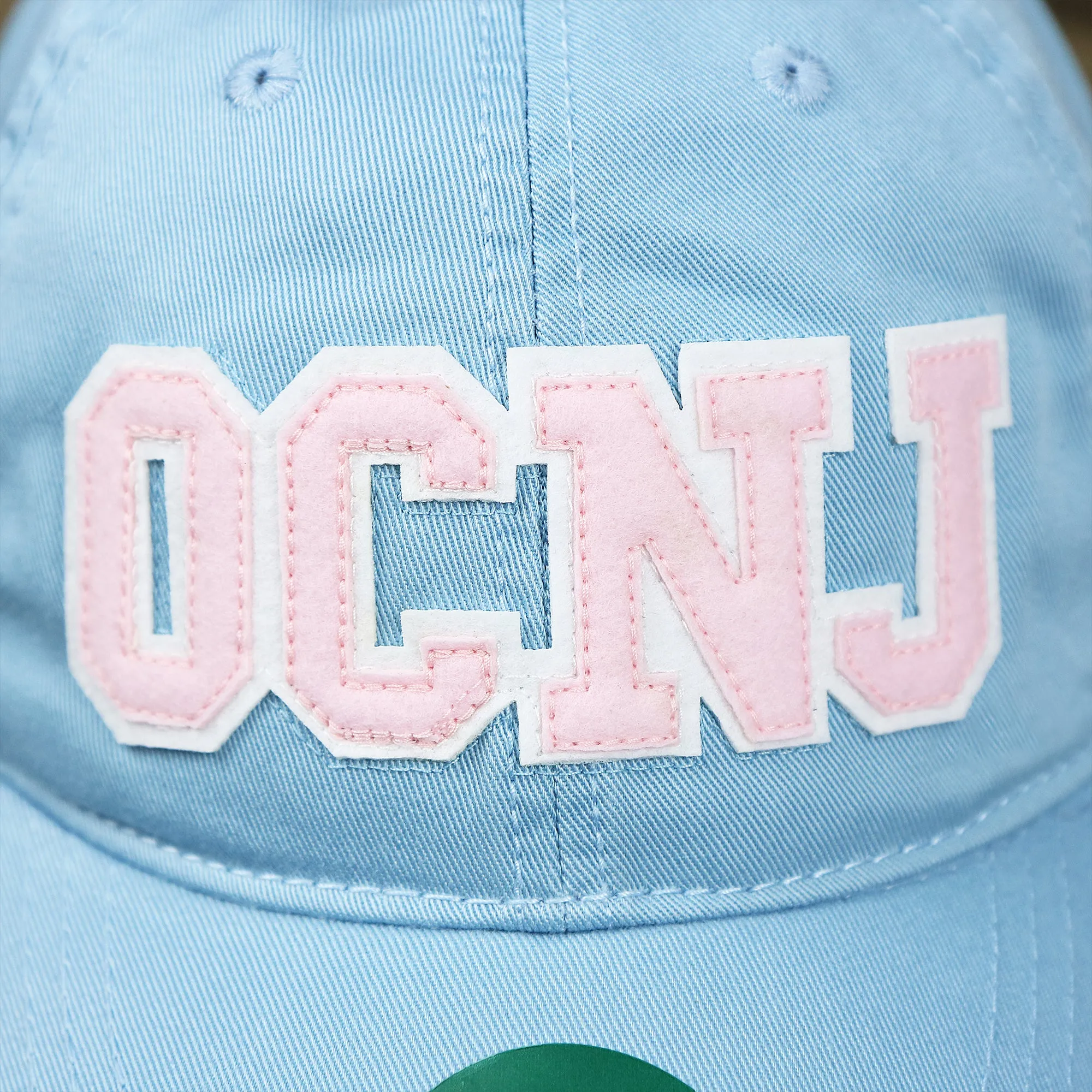 Pink OCNJ Wordmark White Outline Dad Hat | Light Blue Dad Hat