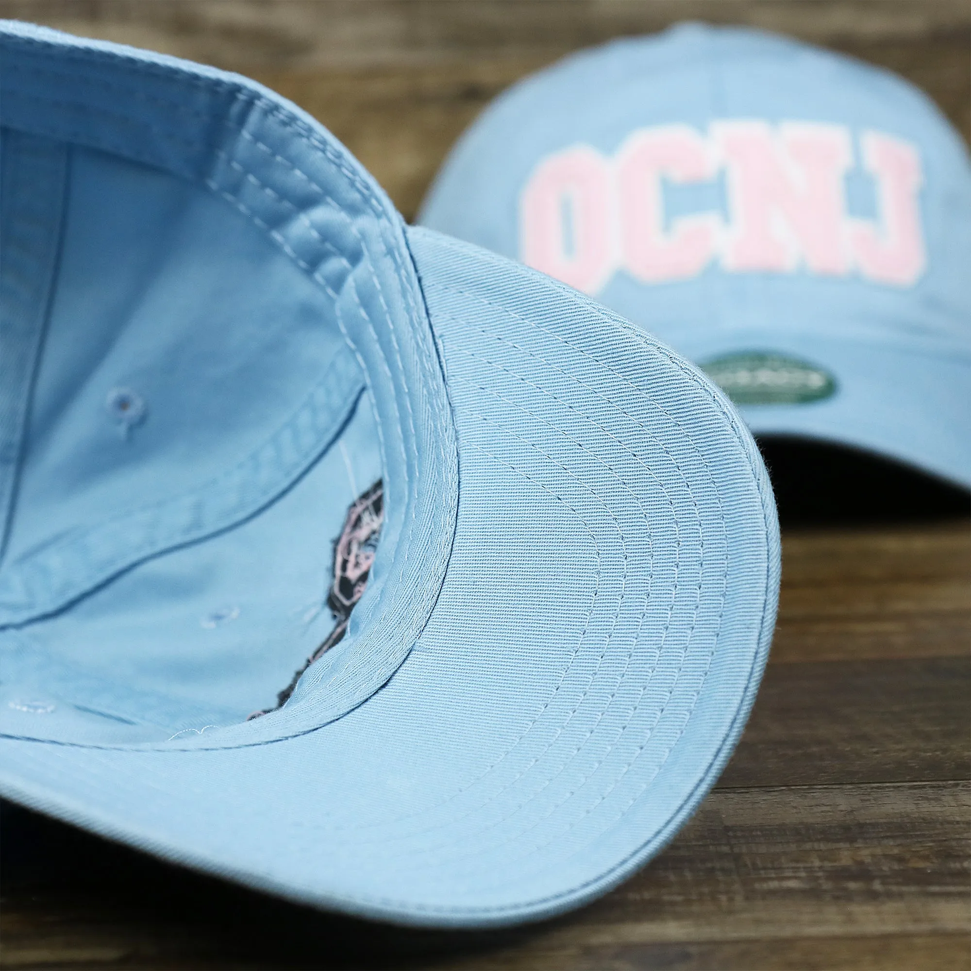 Pink OCNJ Wordmark White Outline Dad Hat | Light Blue Dad Hat