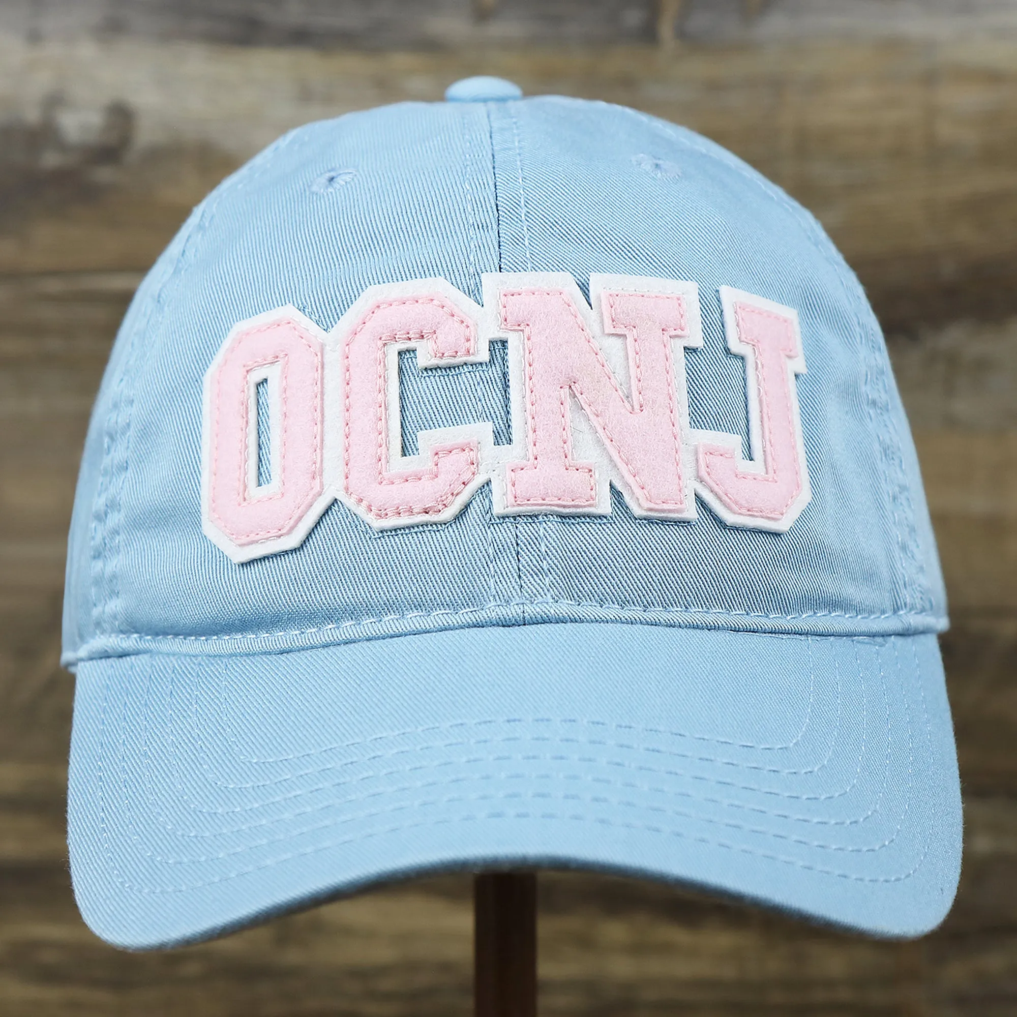 Pink OCNJ Wordmark White Outline Dad Hat | Light Blue Dad Hat